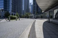 a person sitting at the bench in front of a mall that is empty of people