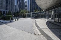 a person sitting at the bench in front of a mall that is empty of people