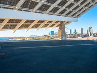 a building made out of solar panels in front of the ocean and a blue sky