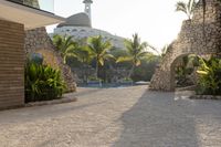 view into the courtyard and pool area of a hotel with mountains in the background of trees