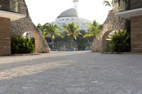 view into the courtyard and pool area of a hotel with mountains in the background of trees