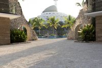 view into the courtyard and pool area of a hotel with mountains in the background of trees