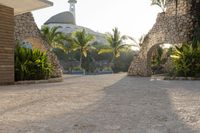 view into the courtyard and pool area of a hotel with mountains in the background of trees