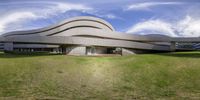 an architecture that looks like it was made of concrete and grass in front of a blue sky