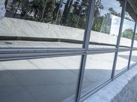 a blurry shot of the reflection of a skate park in the windows of a building