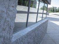 a blurry shot of the reflection of a skate park in the windows of a building