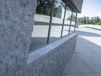 a blurry shot of the reflection of a skate park in the windows of a building