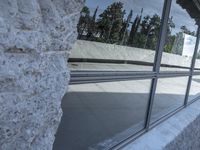 a blurry shot of the reflection of a skate park in the windows of a building