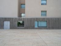 empty area outside concrete building with no people or vehicles at the entrance to area behind it