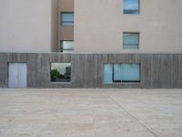 empty area outside concrete building with no people or vehicles at the entrance to area behind it