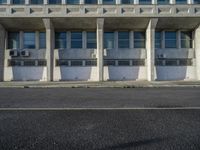 an empty street with concrete buildings in the background and no cars outside to the side