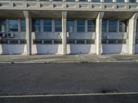 an empty street with concrete buildings in the background and no cars outside to the side