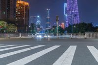 a city street with buildings and neon lights at night time in hong china as seen from an empty city highway