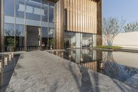 the walkway between the three buildings has mirrors in it, which are reflecting the water