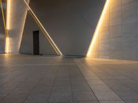 a hallway with columns on the wall that have led lights coming out of them and a door is behind the wall