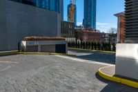 a parking lot with no cars on a sunny day next to tall buildings in the distance