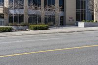 an empty city street with a fire hydrant next to it and a building with a few windows