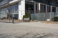 a building with glass on the sides is shown in this picture a bike is parked on the sidewalk