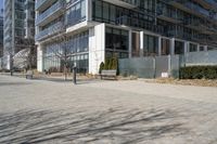 a building with glass on the sides is shown in this picture a bike is parked on the sidewalk