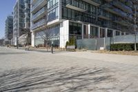 a building with glass on the sides is shown in this picture a bike is parked on the sidewalk