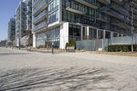 a building with glass on the sides is shown in this picture a bike is parked on the sidewalk