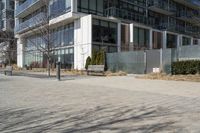 a building with glass on the sides is shown in this picture a bike is parked on the sidewalk