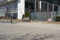 a building with glass on the sides is shown in this picture a bike is parked on the sidewalk