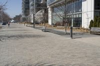 a building with glass on the sides is shown in this picture a bike is parked on the sidewalk