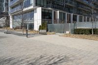 a building with glass on the sides is shown in this picture a bike is parked on the sidewalk