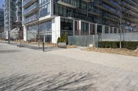 a building with glass on the sides is shown in this picture a bike is parked on the sidewalk