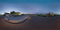 a panorama lens in front of a building on the corner of the street at dusk