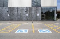 the car parking spaces have markings indicating wheelchairs and no parking signs around them, including in the number