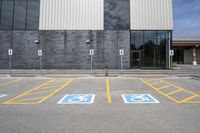 the car parking spaces have markings indicating wheelchairs and no parking signs around them, including in the number