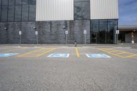 the car parking spaces have markings indicating wheelchairs and no parking signs around them, including in the number