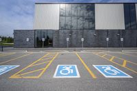 the car parking spaces have markings indicating wheelchairs and no parking signs around them, including in the number