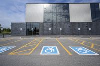 the car parking spaces have markings indicating wheelchairs and no parking signs around them, including in the number