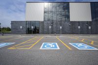 the car parking spaces have markings indicating wheelchairs and no parking signs around them, including in the number