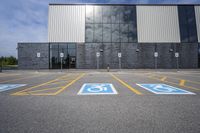 the car parking spaces have markings indicating wheelchairs and no parking signs around them, including in the number