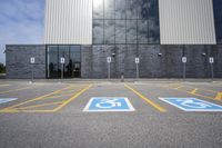 the car parking spaces have markings indicating wheelchairs and no parking signs around them, including in the number