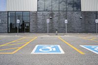 the car parking spaces have markings indicating wheelchairs and no parking signs around them, including in the number