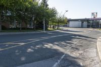 a street has a line of street lights near it on the corner of an empty street