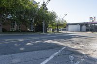 a street has a line of street lights near it on the corner of an empty street