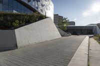 a view of an outside area of an office building with large windows and a circular driveway