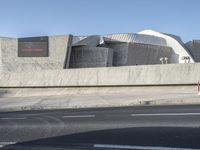 the building is designed like a tunnel and a modern structure on a highway with a ramp