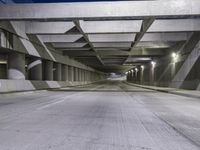 an empty parking garage with no people in it at night time time with only one stop sign