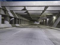 an empty parking garage with no people in it at night time time with only one stop sign