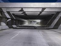 an empty parking garage with no people in it at night time time with only one stop sign
