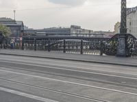 a large bridge with cars crossing it across the road from another bridge to the city