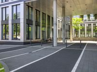 a building with a bicycle parked in the sidewalk at the entrance to it on the street