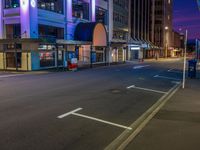 a night time scene with a street light and buildings around it that is empty for all to see